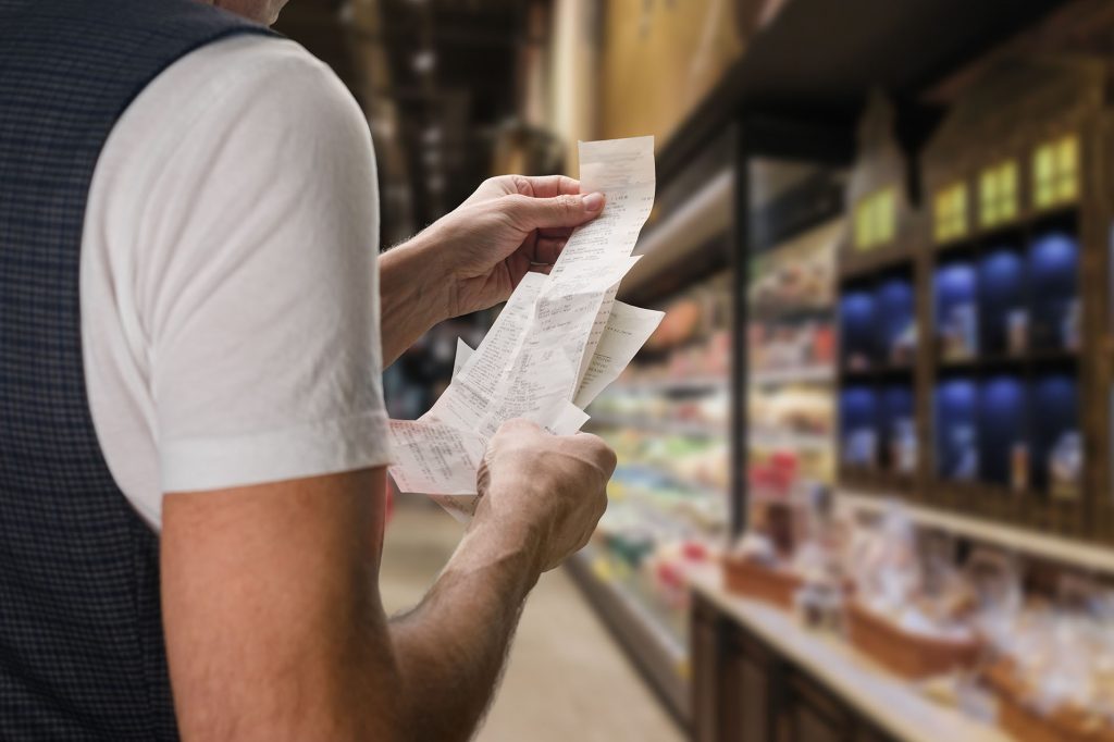 Close up of man holding a bill to the check price